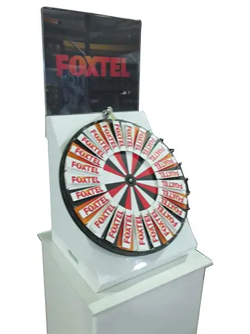 Foxtel-branded wheel segments in an angled white plinth, with a clear logo header above