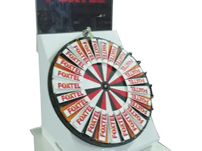 Foxtel-branded wheel segments in an angled white plinth, with a clear logo header above