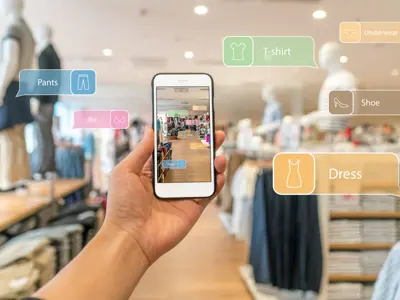 Phone screen showing augmented reality labels for pants, shoes and dresses on clothing racks