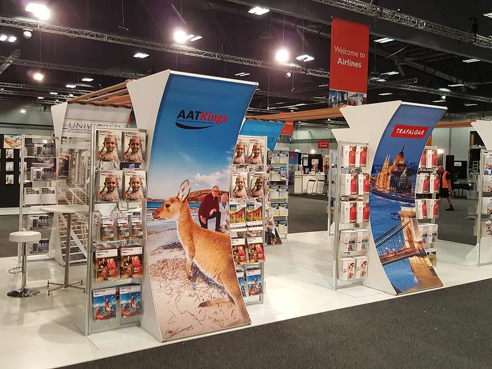 Curved AAT Kings and Trafalgar travel panels with brochure racks and destination images