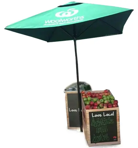 Green Woolworths Love Local umbrella shading timber crates of Adelaide Hills apples