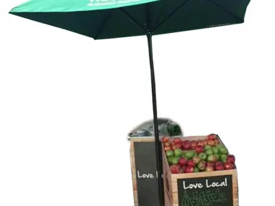 Green Woolworths Love Local umbrella shading timber crates of Adelaide Hills apples