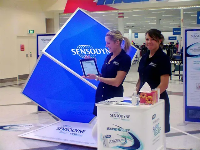 Large Sensodyne cube tilted on its corner behind a Rapid Relief counter with a tablet