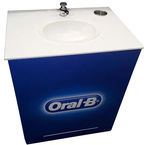 Oral-B white plinth with a basin, working tap and cup holder set into its top