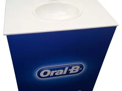 Oral-B white plinth with a basin, working tap and cup holder set into its top