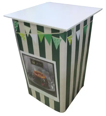 Green and white striped counter with bunting and a framed food photo on the front