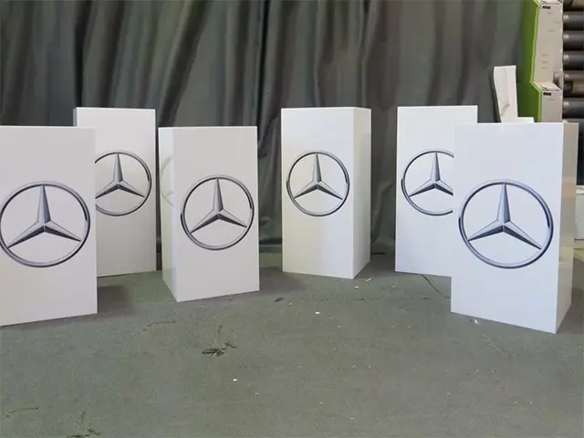 Six white plinths printed with the Mercedes-Benz star