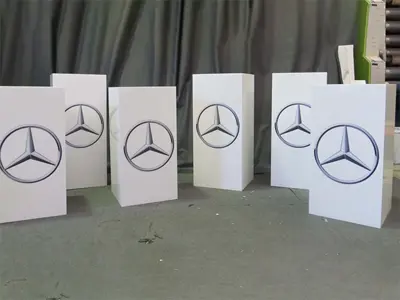 Six white plinths printed with the Mercedes-Benz star