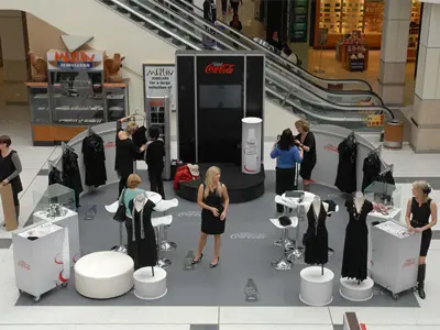 Diet Coca-Cola fashion activation with mannequins, clothing rails and white cabinets in a mall atrium