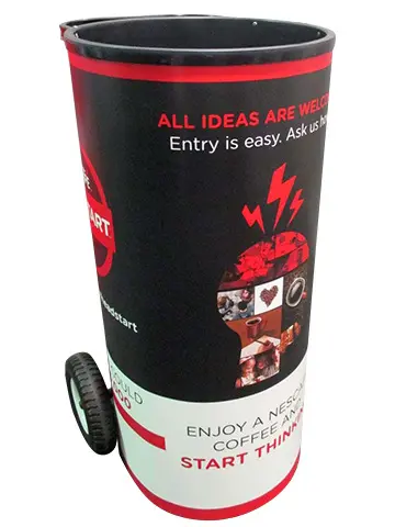 Red and black coffee drum trolley on wheels with an All ideas are welcome message