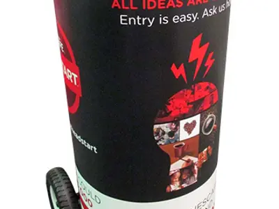 Red and black coffee drum trolley on wheels with an All ideas are welcome message