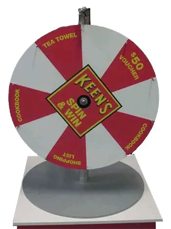 Keen's Spin & Win wheel with red prize segments on a round steel base