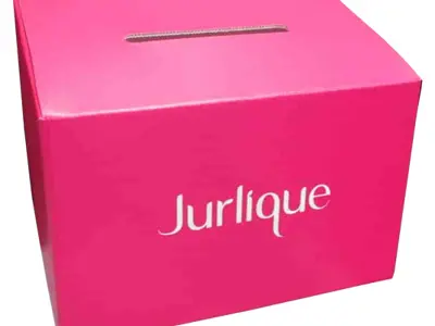 Vivid pink Jurlique corflute box with a white logo and a slot in the lid