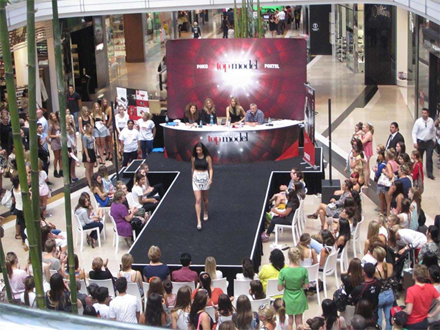 Australia's Next Top Model runway and branded judges' desk at a Westfield shopping centre activation