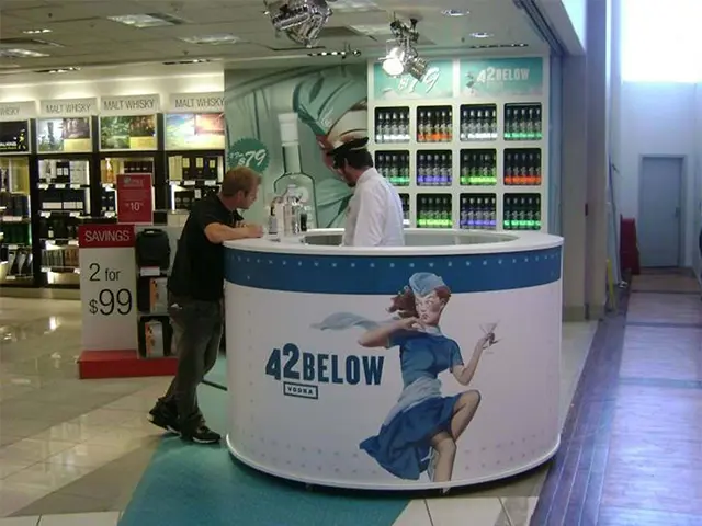 Round 42 Below counter with pin-up artwork in a liquor store with branded shelving