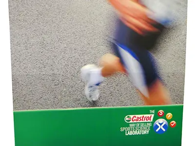 Castrol Steps Matter fabric wall with a runner photo above a green logo strip
