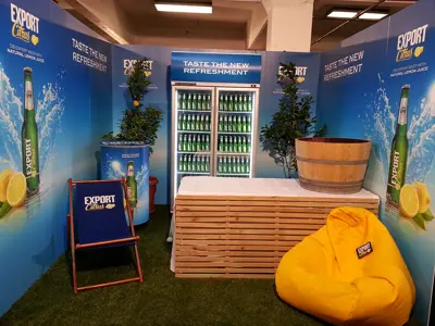 Export Citrus stand with a lit beer fridge, lemon graphics, citrus trees and beanbag