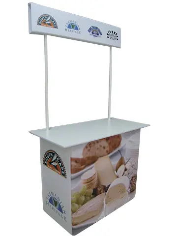 Cheese sampling table with a header board showing South Cape and Tasmanian Heritage logos