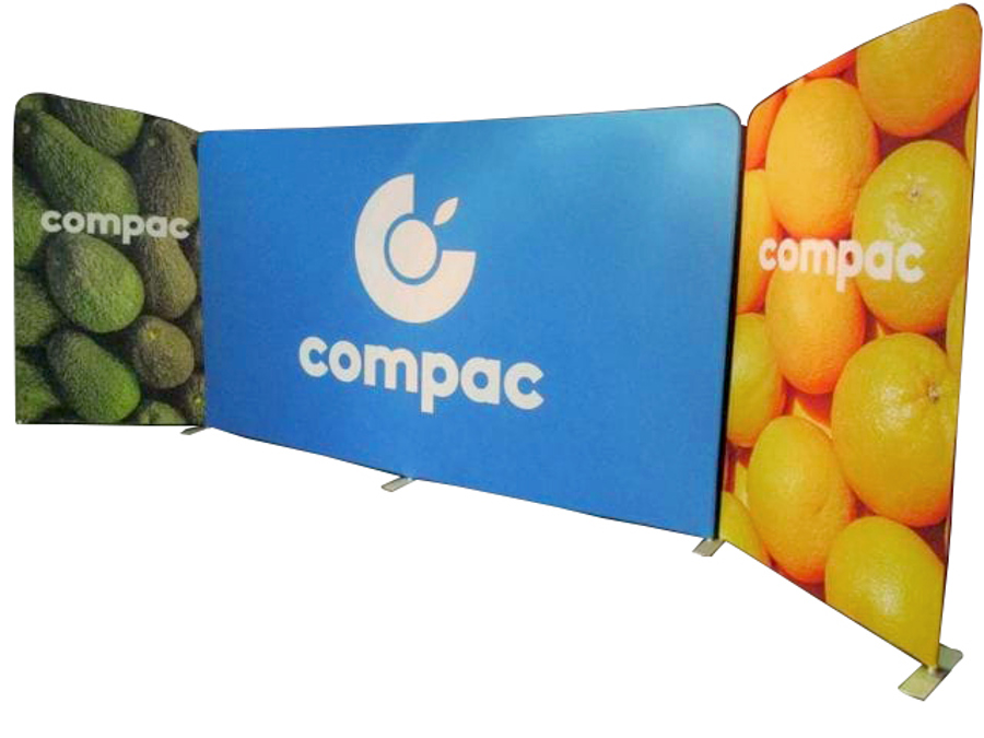 Three free-standing fabric walls with rounded corners on flat feet, the centre wall printed with a blue logo panel and the side walls with photos of avocados and oranges
