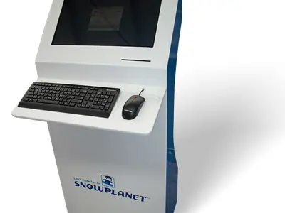 Freestanding Snowplanet kiosk with an angled recessed screen above a keyboard and mouse shelf