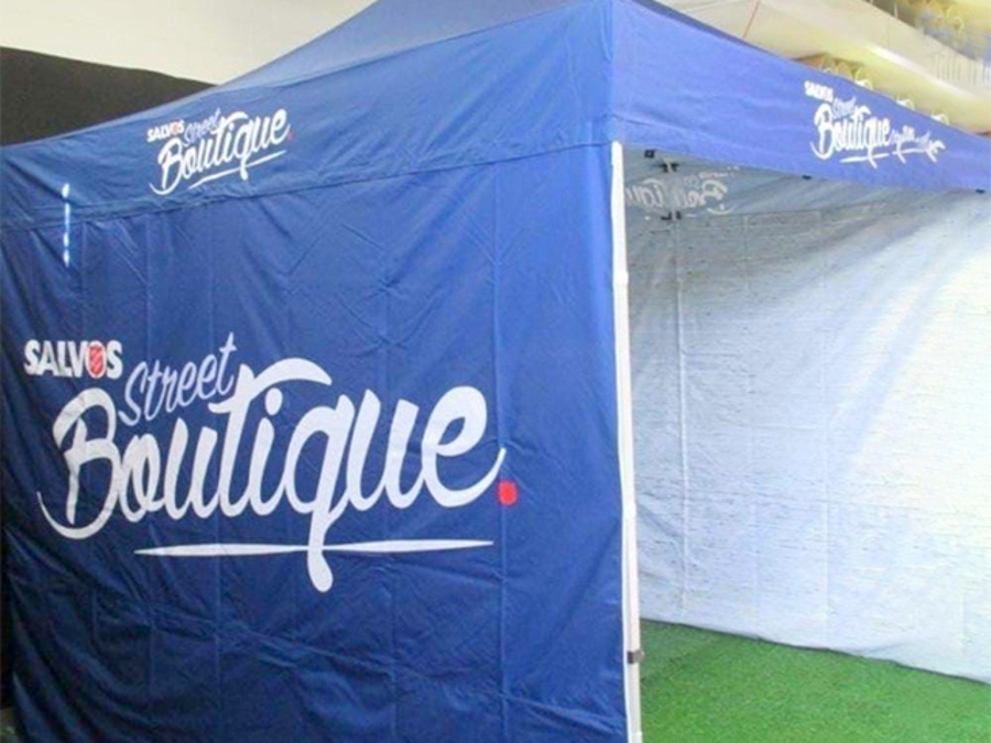Blue pop-up marquee printed with "Salvos Street Boutique" on the canopy valance and a full-height side wall