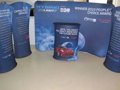 Toyota Hybrid Camry kit with curved offer towers, a backdrop and a round counter