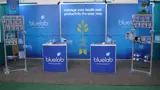 Exhibition stand graphics with counters and product racks
