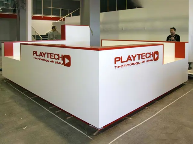 White Playtech booth with red trim, low walls and raised Technology at play lettering