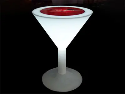 Glowing white martini glass cocktail table with a red branded inset on top