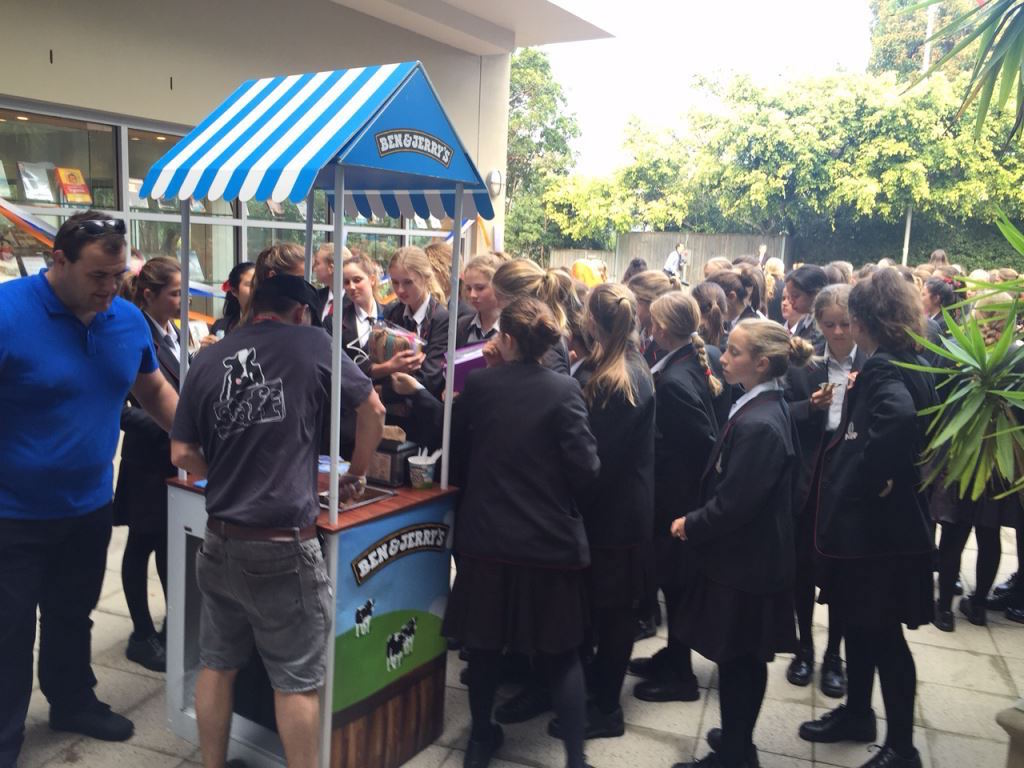 Ben & Jerry's branded sampling cart set up outside a school building