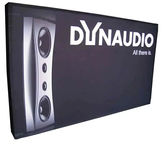 Black Dynaudio wall with a large speaker image and print wrapping around its edges