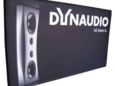 Black Dynaudio wall with a large speaker image and print wrapping around its edges