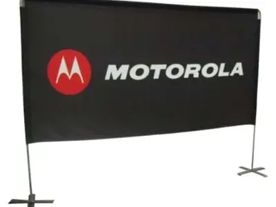 Black Motorola banner with a white and red logo on a frame with cross-shaped feet