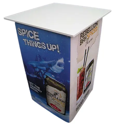 Rebellion Bay Spiced rum table with Spice things up shark artwork on its front