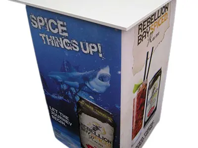 Rebellion Bay Spiced rum table with Spice things up shark artwork on its front