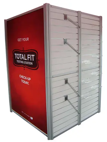 Total Fit Testing Station cube with a red graphic side and slatwall waterfall arms
