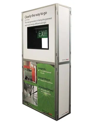 Legrand display tower with a lit LED exit sign above printed product information panels