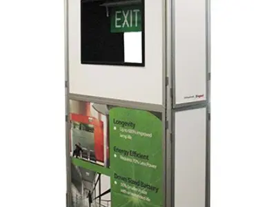 Legrand display tower with a lit LED exit sign above printed product information panels