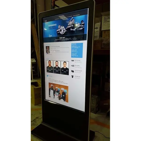 Tall portrait kiosk showing a rugby website with 'Experience the Haka Challenge' and player profiles