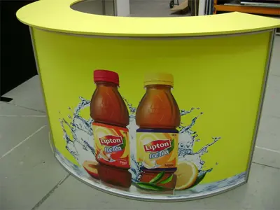 Curved Lipton Ice Tea counter wrapped in peach and lemon bottle graphics with fruit splashes