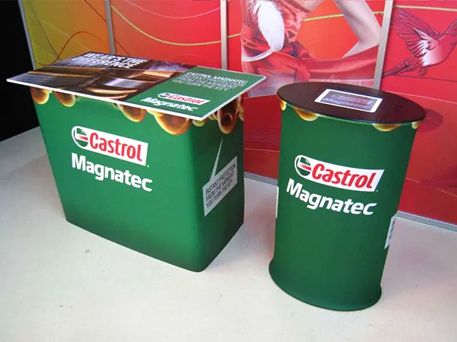 Green Castrol Magnatec counter beside an oval plinth with a screen set into the top
