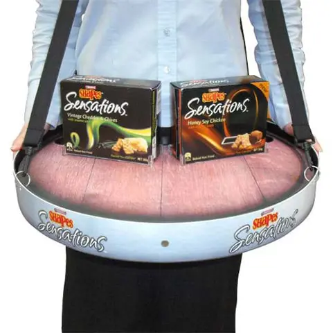 Shapes Sensations tray holding two flavour boxes, worn by a promoter on shoulder straps