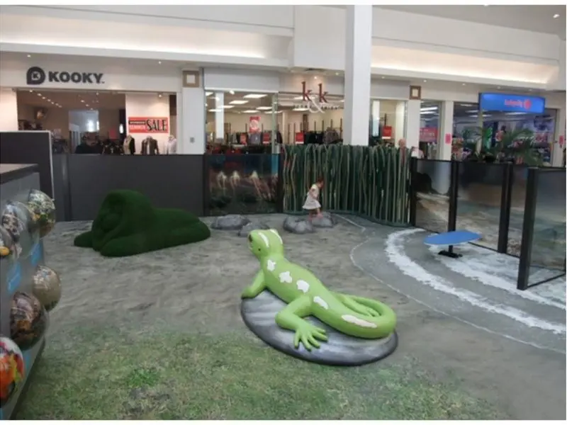 Printed nature-themed floor carpet with gecko sculpture display, wide view