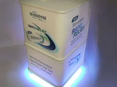 Sensodyne Rapid Relief cube with large pack graphics and a glowing LED base