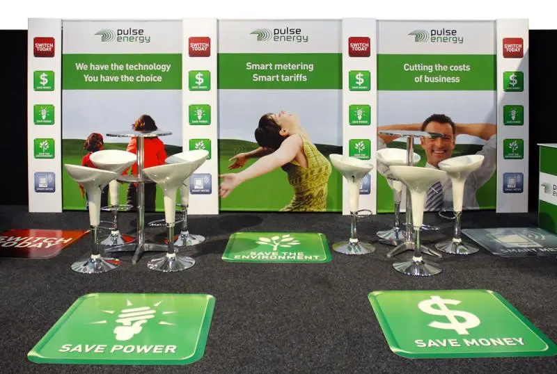 Pulse Energy stand with Save Power floor decals, bar tables and white stools