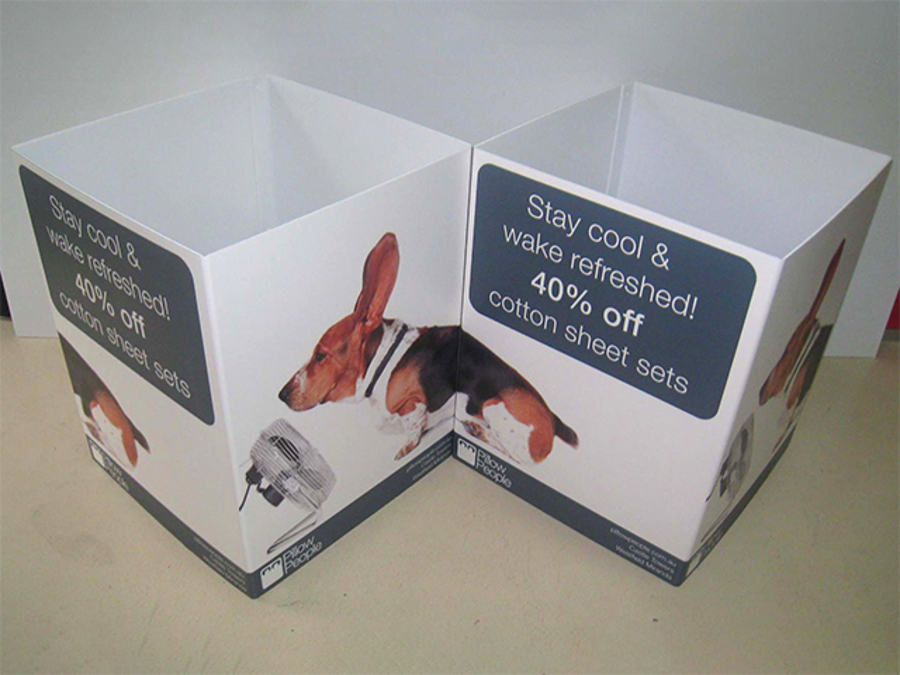Two white printed cardboard floor bins joined side by side, each carrying a 40% off offer panel and a photo of a dog