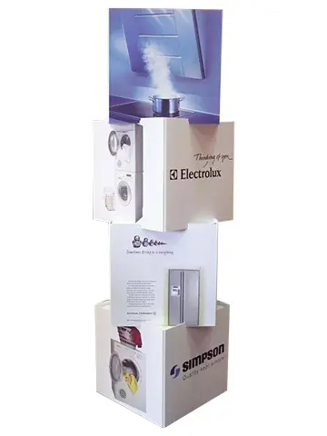 Electrolux and Simpson appliance cubes stacked at angles under a tall graphic panel