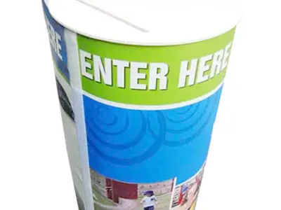 Green and blue cylinder with a bold 'ENTER HERE' band and a lid slot