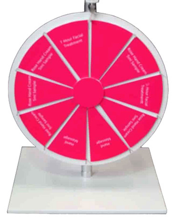 Counter-top prize wheel with pink segments offering a facial, hand massage and hand cream samples