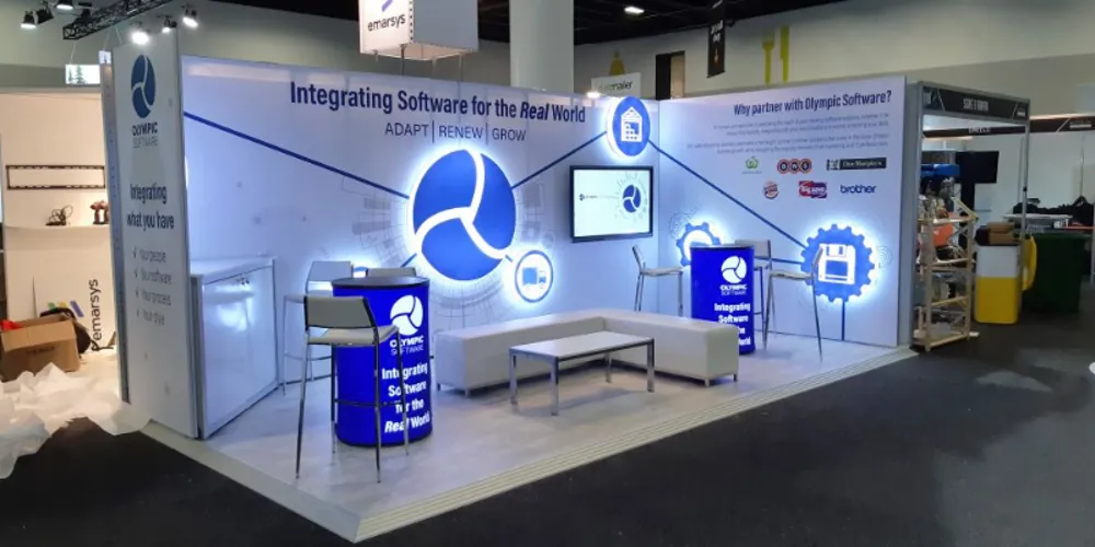 Olympic Software exhibition stand lit up, showing the counter and seating bench